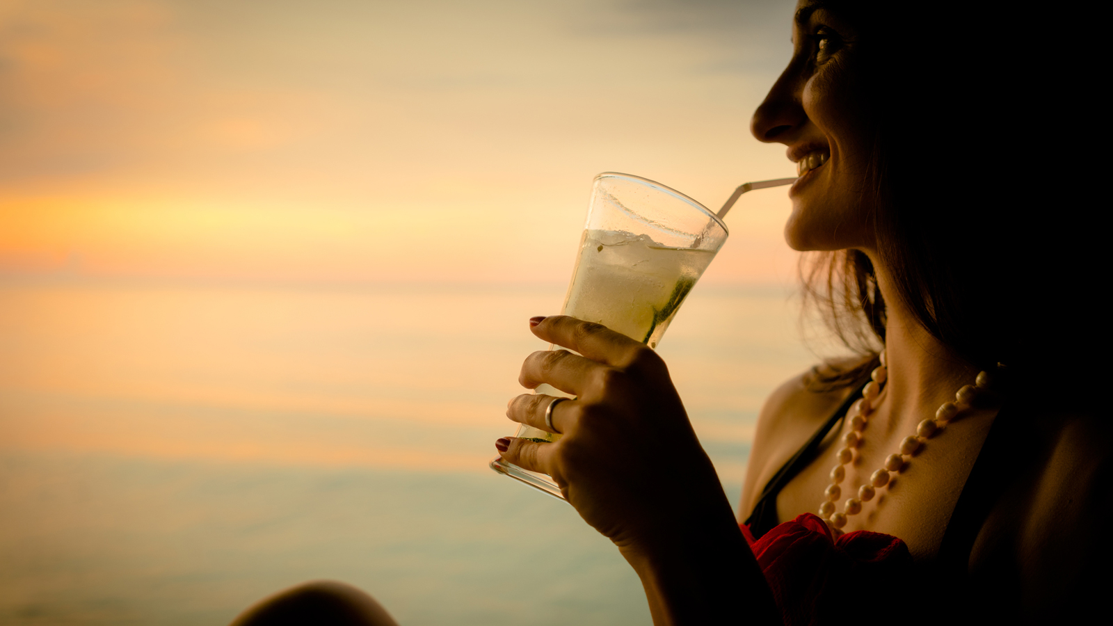 Woman Drinking Cocktail At Sunset In Key West FL